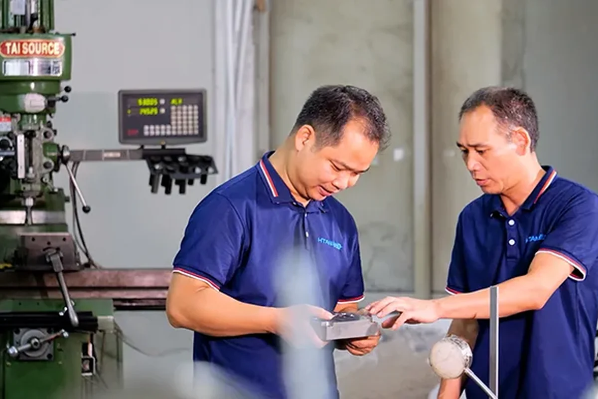 HTAN staff reviewing a manufactured metal component