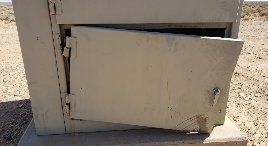 Severe cabinet door sag on an outdoor enclosure caused by incorrect heavy-duty hinge selection